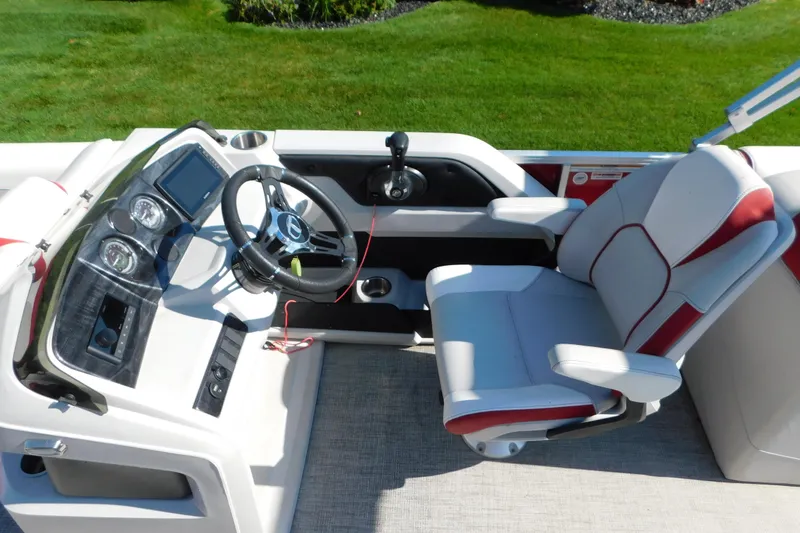 Slide: The Image of 2023 Tahoe Pontoon 2385 LTZ Quad Lounger helm with steering wheel and captain's chair. - 29