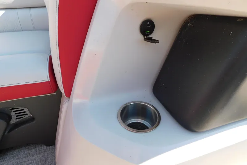 Slide: The Image of 2023 Tahoe Pontoon 2385 LTZ Quad Lounger interior with red and white seating, cup holder, and USB port. - 49
