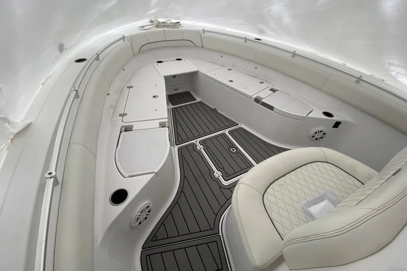 Slide: The Image of 2020 Sportsman Open 282 Center Console boat interior with cushioned seating and storage compartments. - 11