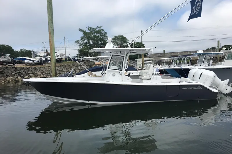 Slide: The Image of 2020 Sportsman Open 282 Center Console boat docked in a marina. - 13
