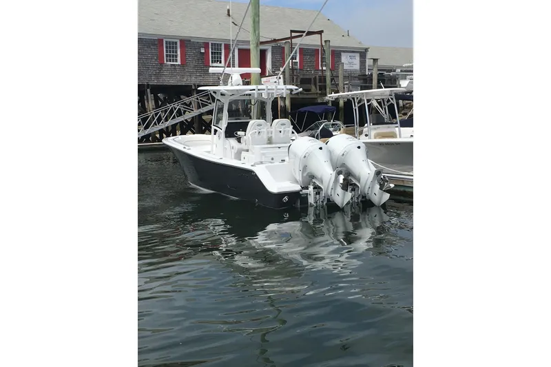 Slide: The Image of 2020 Sportsman Open 282 Center Console boat docked with dual engines. - 14