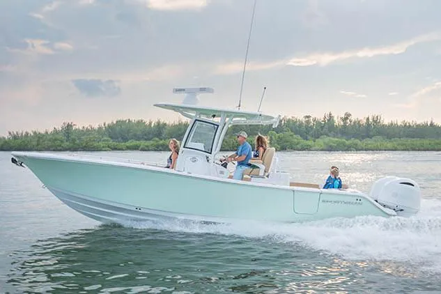 Slide: The Image of Manufacturer Provided Image: 2020 Sportsman Open 282 Center Console boat cruising on water with passengers. - 16