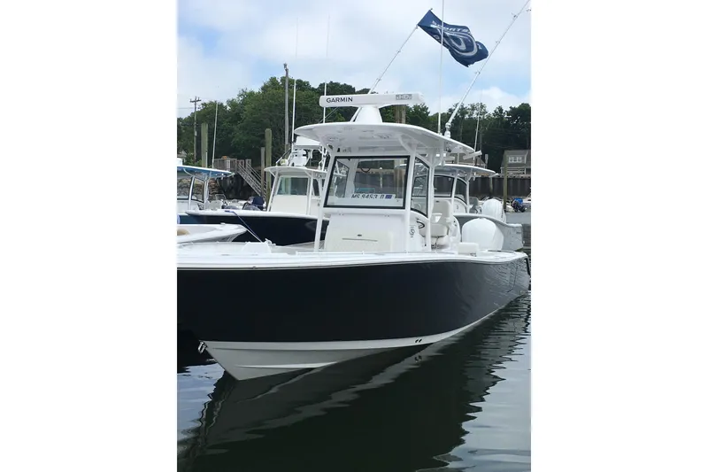 Slide: The Image of 2020 Sportsman Open 282 Center Console boat docked in marina. - 2