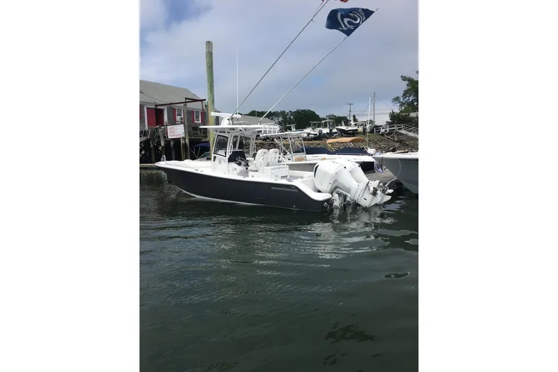 Slide: The Image of 2020 Sportsman Open 282 Center Console boat docked in marina, side view. - 32