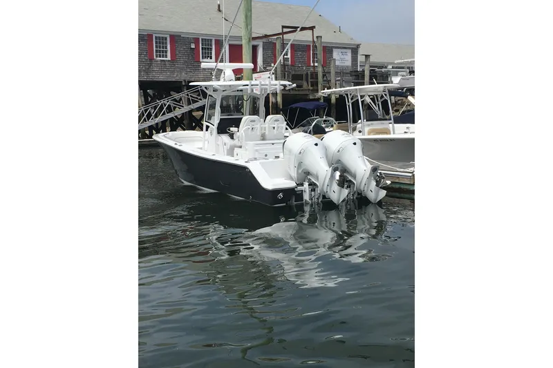 Slide: The Image of 2020 Sportsman Open 282 Center Console boat docked at marina. - 4