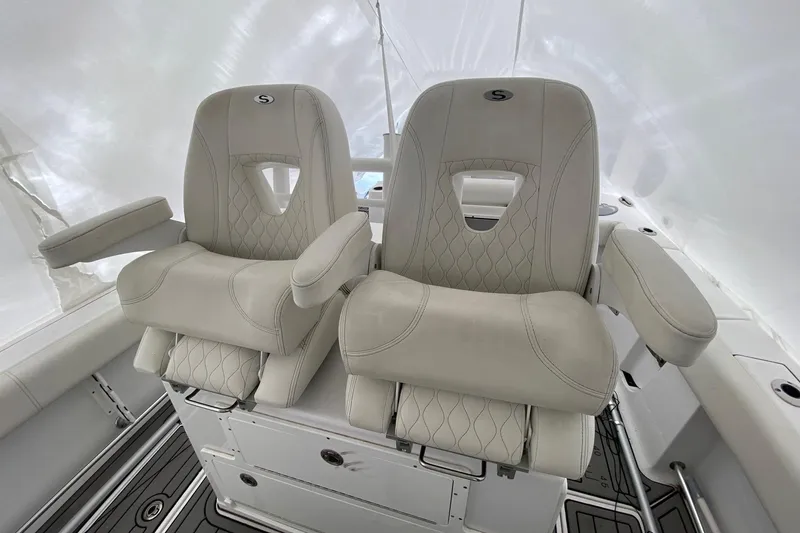 Slide: The Image of 2020 Sportsman Open 282 Center Console boat seats, featuring luxurious beige upholstery. - 8