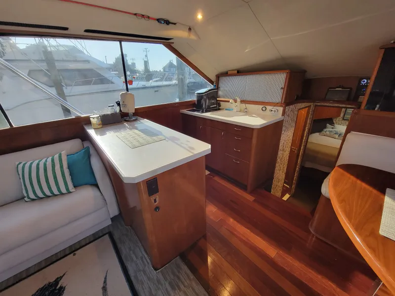 Slide: The Image of Interior of 1991 Ocean Yachts 42 Super Sport with kitchen and seating area. - 12