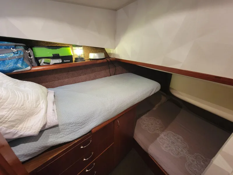 Slide: The Image of 1991 Ocean Yachts 42 Super Sport cabin with twin beds and storage drawers. - 16