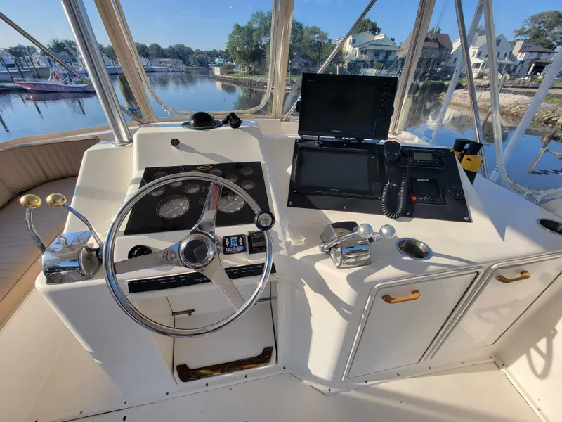 Slide: The Image of Helm station of 1991 Ocean Yachts 42 Super Sport with steering wheel and navigation equipment. - 19