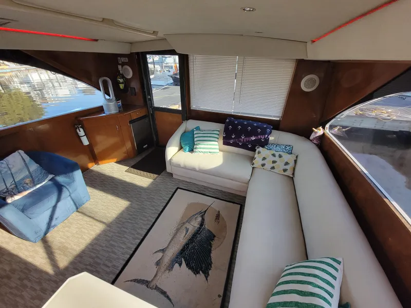 Slide: The Image of Interior of 1991 Ocean Yachts 42 Super Sport with white seating and nautical decor. - 7