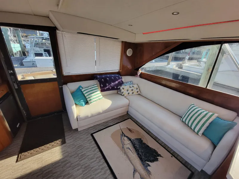 Slide: The Image of Interior of 1991 Ocean Yachts 42 Super Sport with white L-shaped sofa and nautical decor. - 8