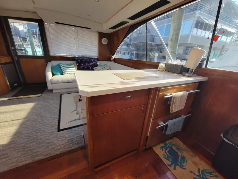 Slide: The Image of Interior of 1991 Ocean Yachts 42 Super Sport with modern kitchen and cozy seating area. - 9