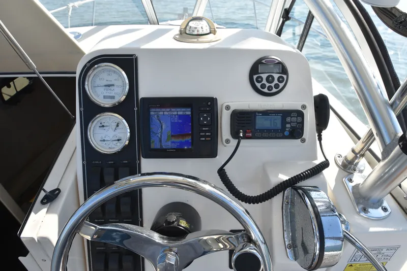 Slide: The Image of Helm console of a 2007 Shamrock 246 Adventurer boat with navigation instruments. - 22