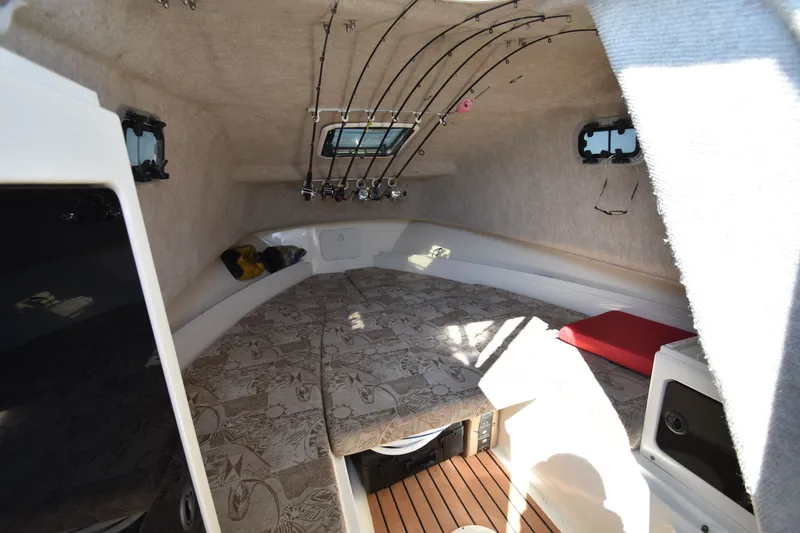 Slide: The Image of Interior of 2007 Shamrock 246 Adventurer with fishing rods. - 24