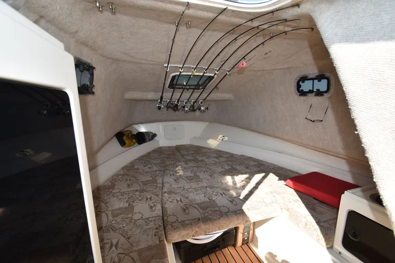 Slide: The Image of Interior of 2007 Shamrock 246 Adventurer with fishing rods. - 25