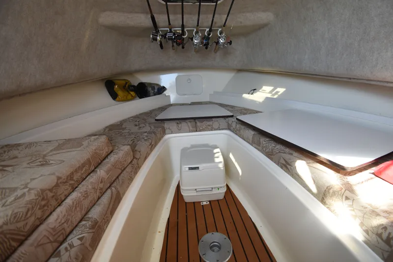 Slide: The Image of Interior of 2007 Shamrock 246 Adventurer with fishing rods and seating area. - 34