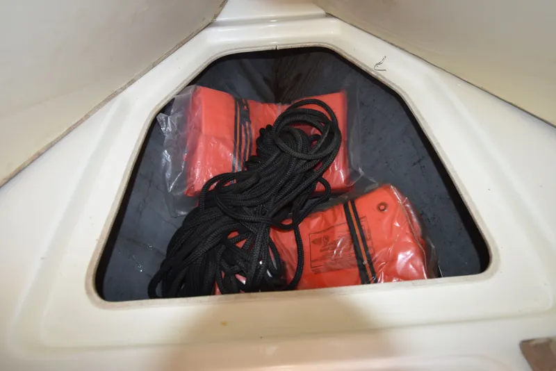 Slide: The Image of Life jackets and rope in storage of a 2007 Shamrock 246 Adventurer. - 37