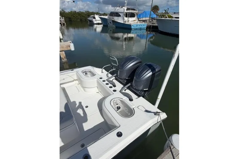 Slide: The Image of 2025 SeaHunter 30 Floridian boat with dual engines docked at marina. - 7