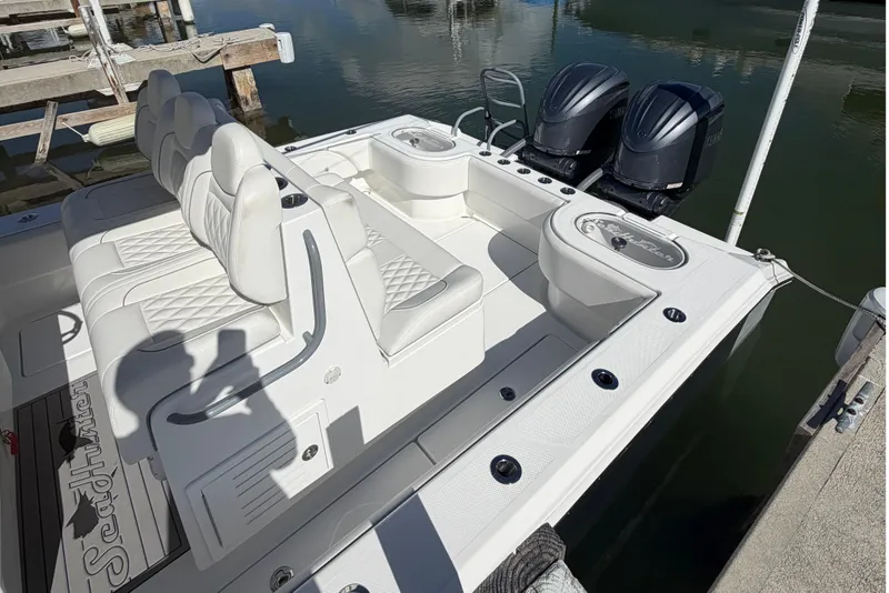 Slide: The Image of 2025 SeaHunter 30 Floridian boat with dual engines, docked, featuring luxurious seating. - 8