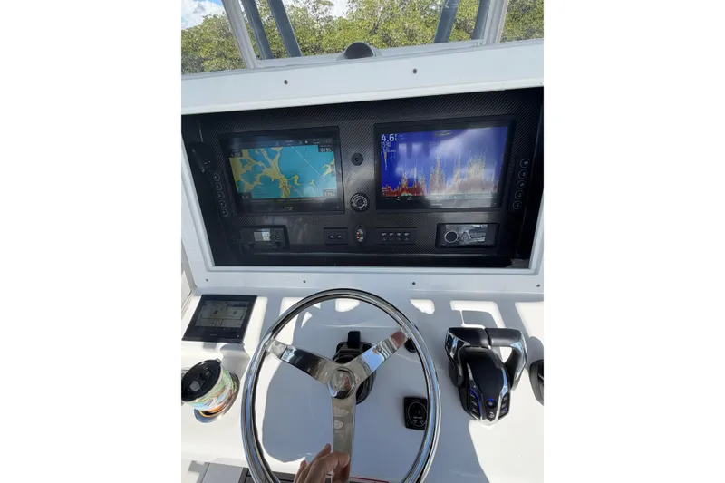 Slide: The Image of 2025 SeaHunter 30 Floridian boat dashboard with navigation screens and steering wheel. - 9