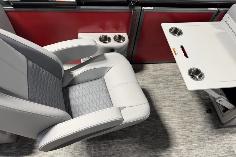 Slide: The Image of 2026 Bentley Pontoons Elite 223 Admiral interior with luxurious seating and table setup. - 14