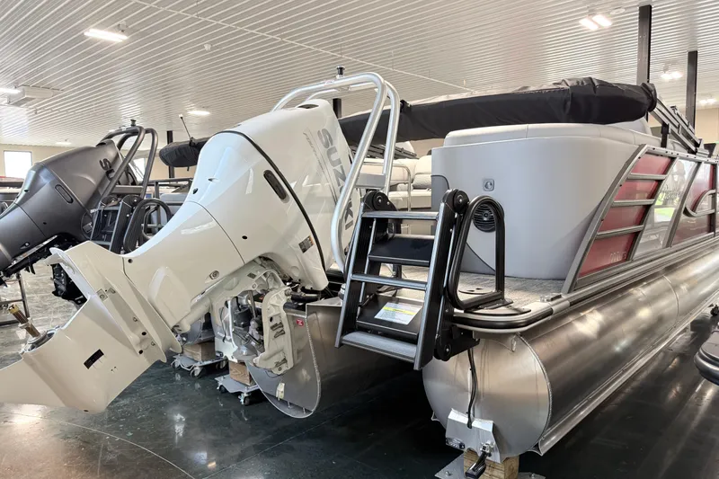 Slide: The Image of 2026 Bentley Pontoons Elite 223 Admiral with Suzuki outboard motor in showroom. - 16