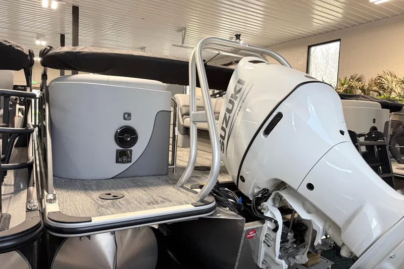 Slide: The Image of 2026 Bentley Pontoons Elite 223 Admiral with Suzuki outboard motor in showroom. - 17