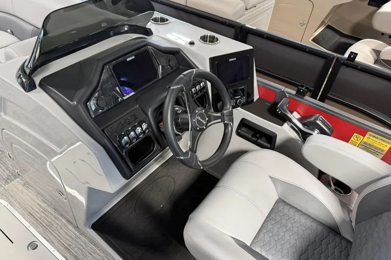 Slide: The Image of 2026 Bentley Pontoons Elite 223 Admiral helm with modern controls and luxurious seating. - 8
