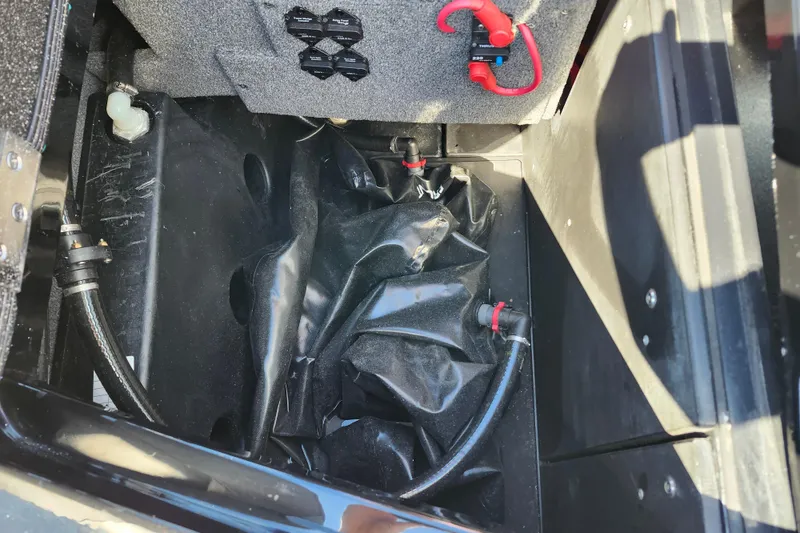 Slide: The Image of 2022 Malibu M220 boat interior showing ballast system components and wiring. - 16