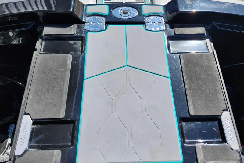 Slide: The Image of 2022 Malibu M220 boat deck with sleek design and textured surface. - 17