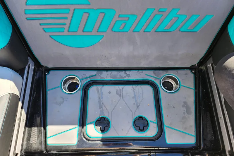 Slide: The Image of 2022 Malibu M220 boat interior with cup holders and logo detailing. - 22