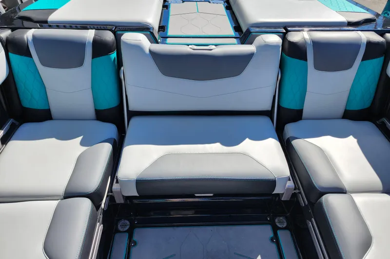 Slide: The Image of 2022 Malibu M220 boat interior with stylish gray and teal seating. - 25