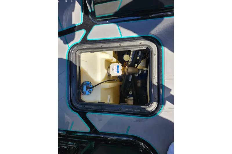 Slide: The Image of 2022 Malibu M220 boat compartment with visible wiring and components. - 29