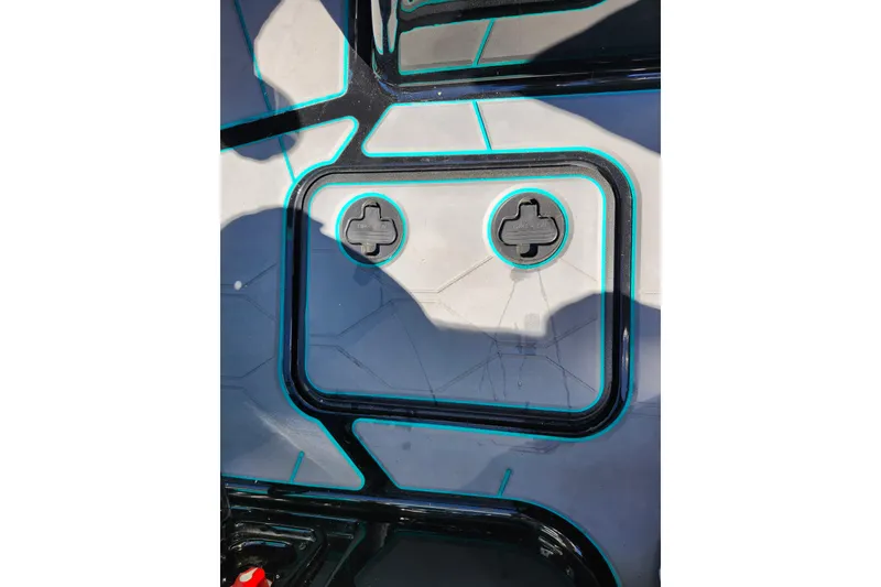 Slide: The Image of 2022 Malibu M220 boat deck with geometric design and teal accents. - 30