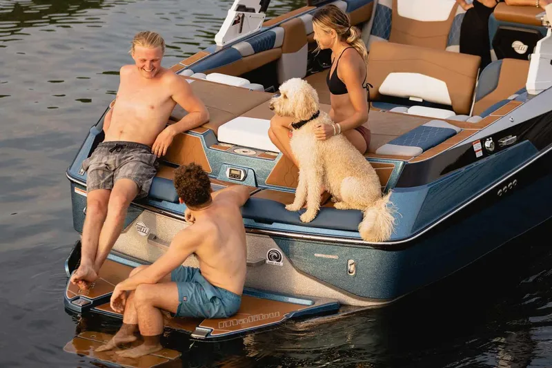 Slide: The Image of 2022 Malibu M220 boat displayed at AM PM Marine dealership. - 4