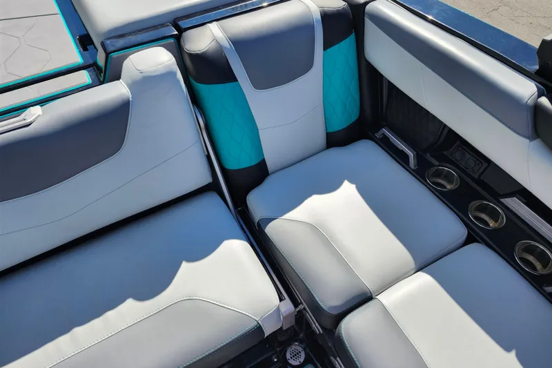 Slide: The Image of 2022 Malibu M220 boat interior with stylish seating and cup holders. - 40