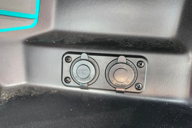 Slide: The Image of 2022 Malibu M220 USB and power outlet panel in black interior. - 47