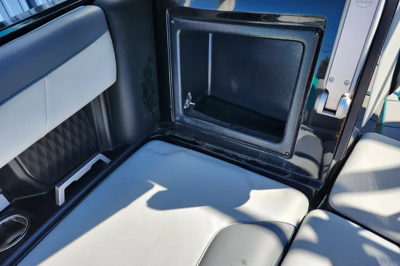 Slide: The Image of 2022 Malibu M220 interior storage compartment with sleek seating design. - 51