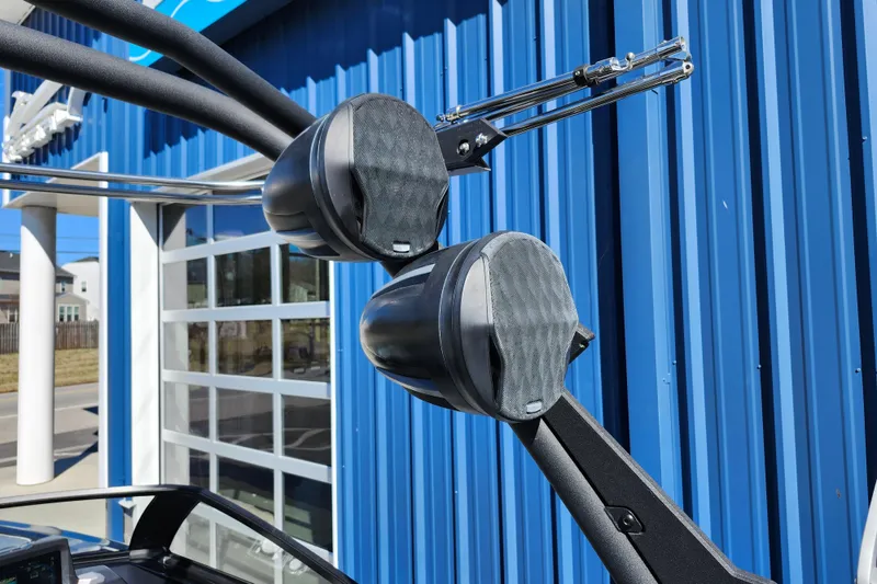 Slide: The Image of 2022 Malibu M220 boat speakers against a blue building background. - 52