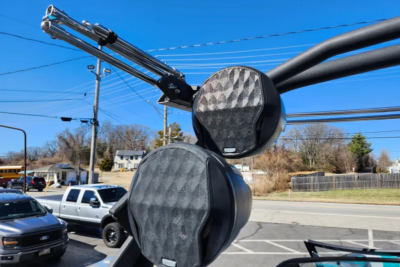 Slide: The Image of 2022 Malibu M220 boat speakers with a clear blue sky background. - 54