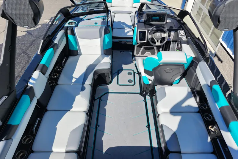 Slide: The Image of 2022 Malibu M220 boat interior with modern seating and advanced dashboard features. - 56