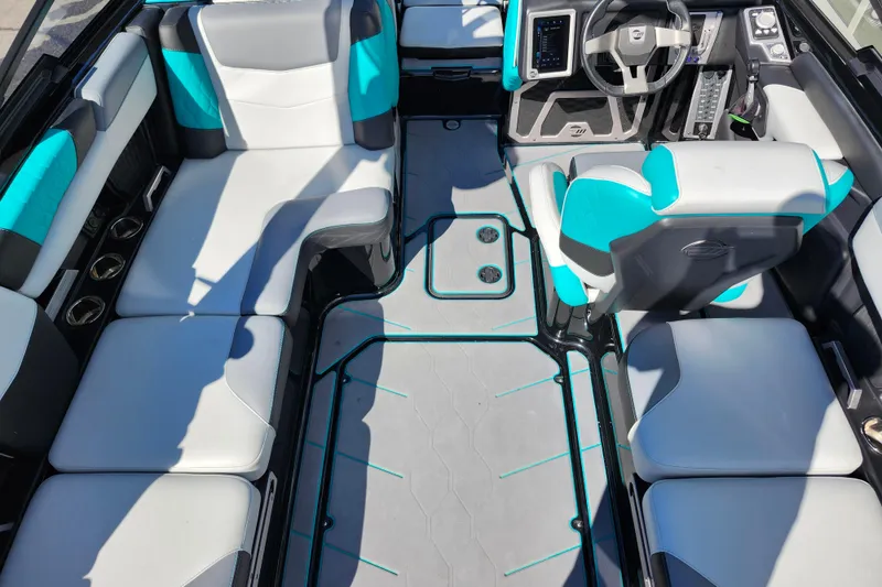 Slide: The Image of 2022 Malibu M220 boat interior with modern seating and sleek dashboard design. - 57