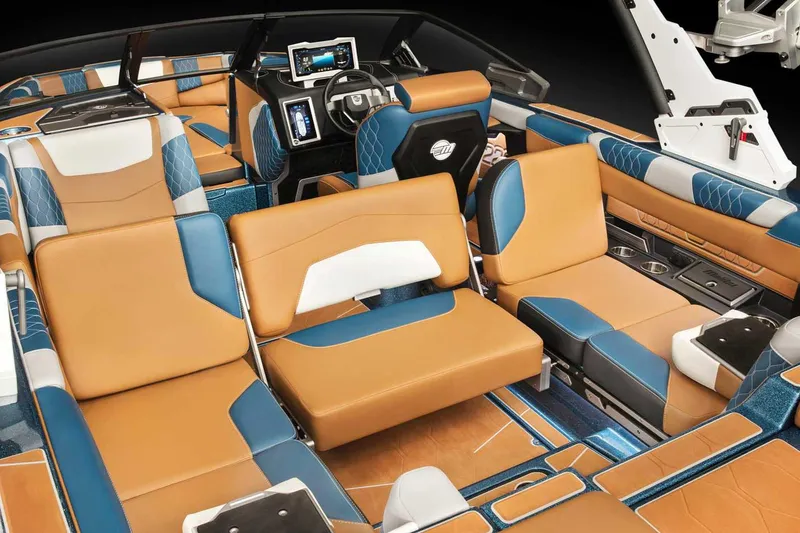 Slide: The Image of Manufacturer Provided Image: 2022 Malibu M220 boat interior with luxurious tan and blue seating, advanced dashboard controls. - 68