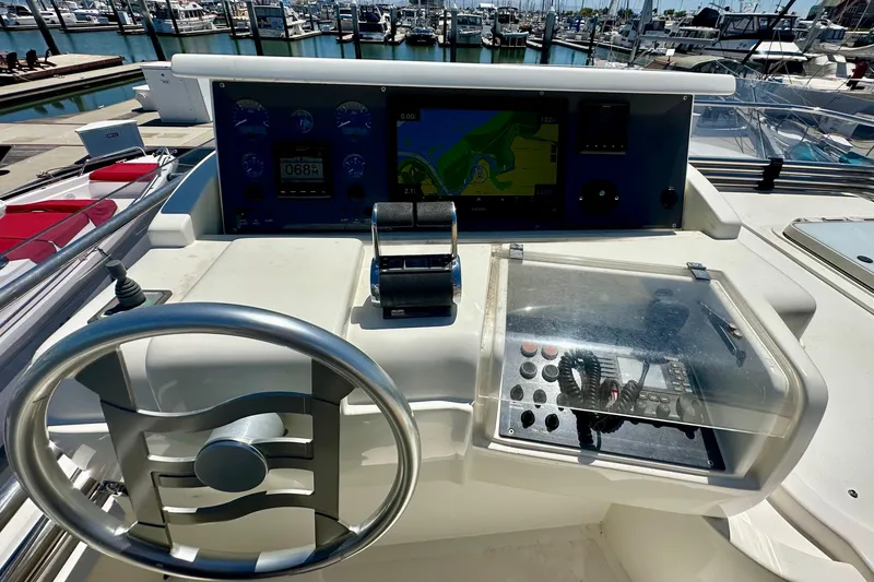Slide: The Image of Helm of 2006 Ferretti Yachts 550 with navigation controls and marina view. - 11