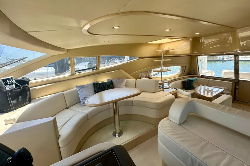 Slide: The Image of Luxurious interior of a 2006 Ferretti Yachts 550 with elegant seating and panoramic windows. - 13
