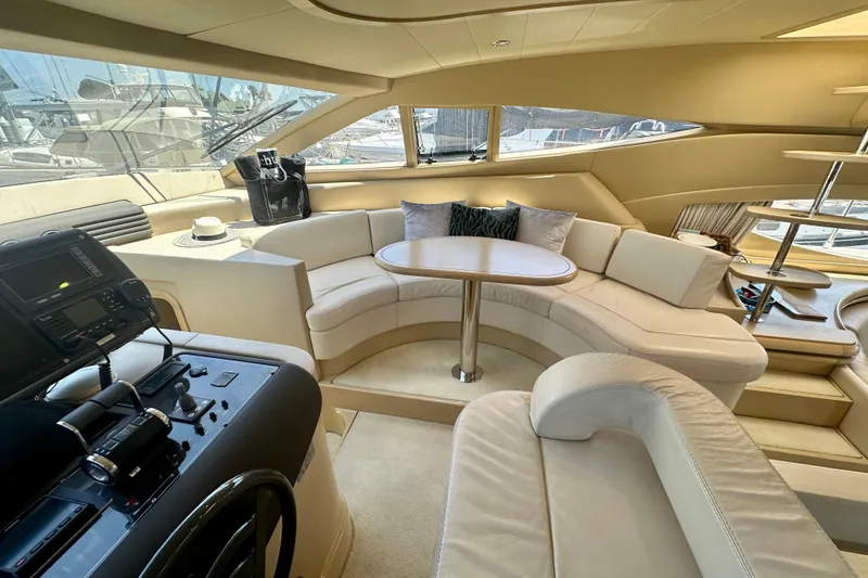 Slide: The Image of Luxurious interior of 2006 Ferretti Yachts 550 with plush seating and helm controls. - 14