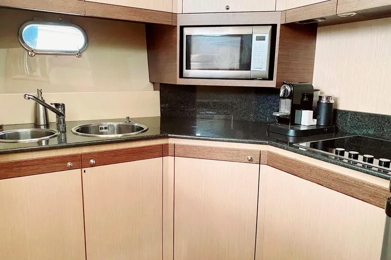 Slide: The Image of Modern kitchen in 2006 Ferretti Yachts 550 with microwave, coffee maker, and dual sinks. - 18