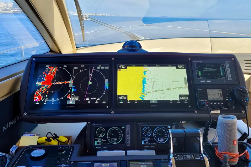 Slide: The Image of Control panel of a 2006 Ferretti Yachts 550 with navigation screens and instruments. - 20