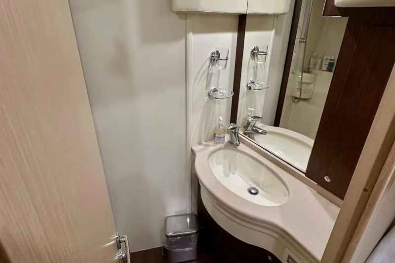Slide: The Image of Bathroom interior of 2006 Ferretti Yachts 550, featuring a modern sink and mirror. - 22