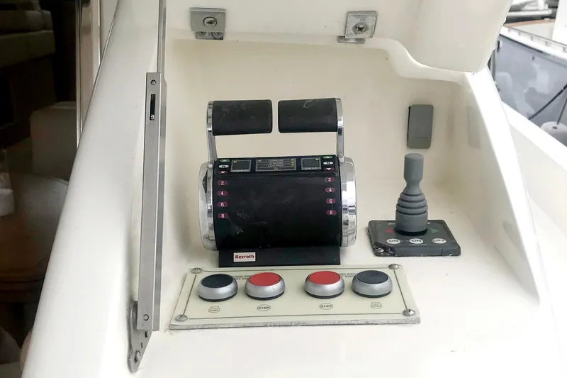 Slide: The Image of Control panel of a 2006 Ferretti Yachts 550, featuring throttle and joystick controls. - 23